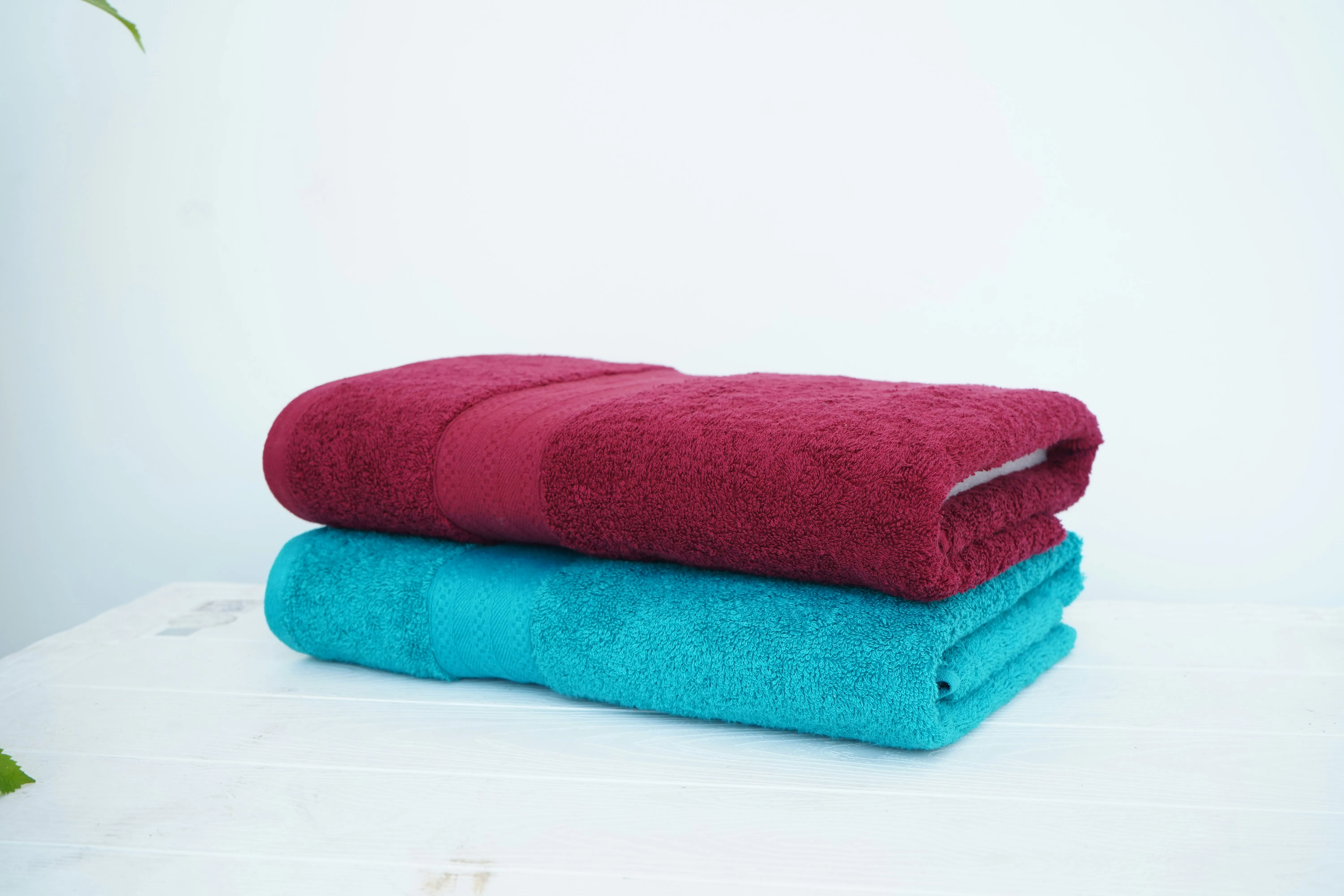 Stack of folded towels used to catch washing machine drain water