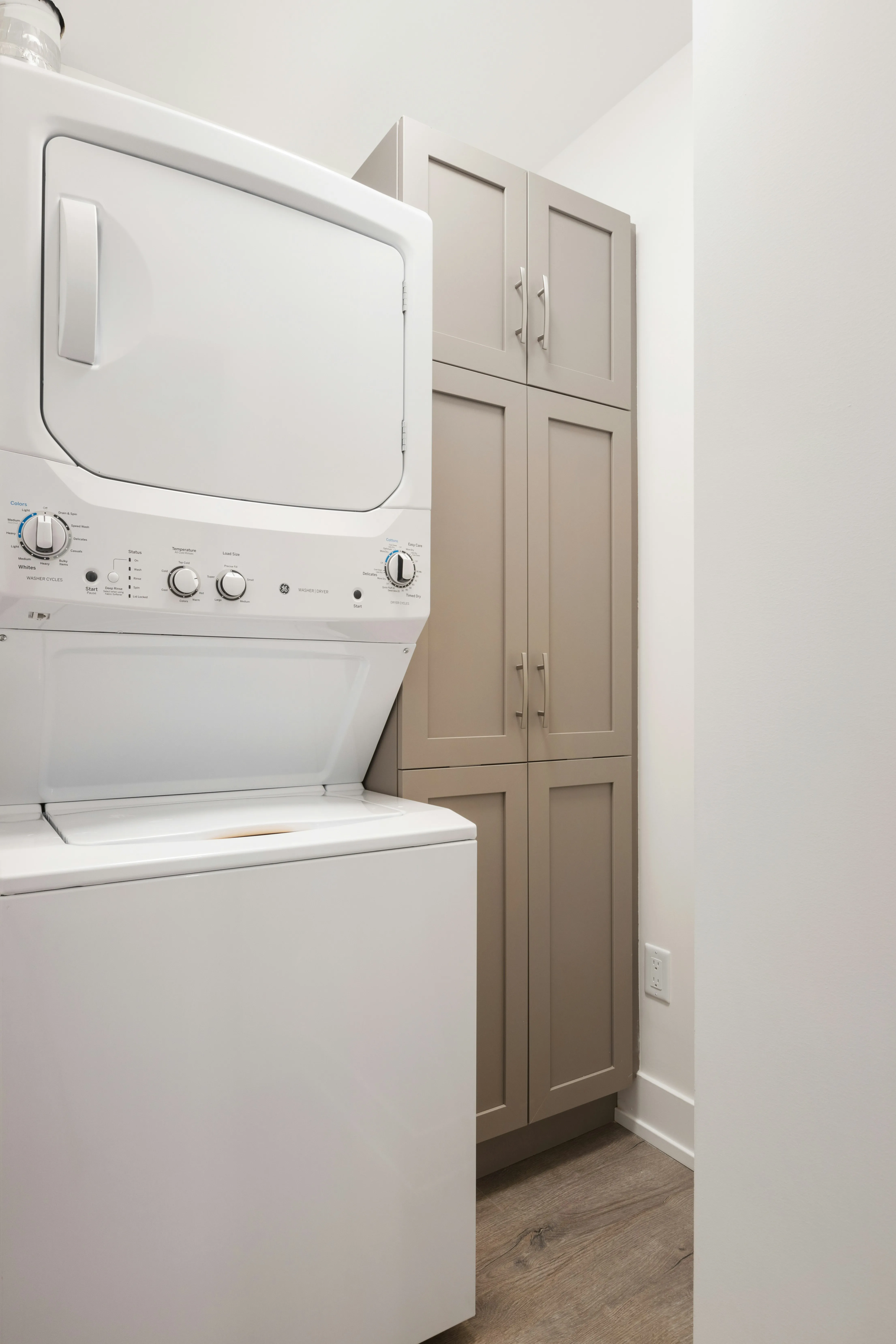 A white front load washing machine ready for the shoes and towels
